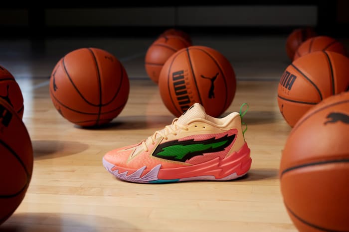 Side view of Scoot Henderson's peach and green PUMA sneakers.